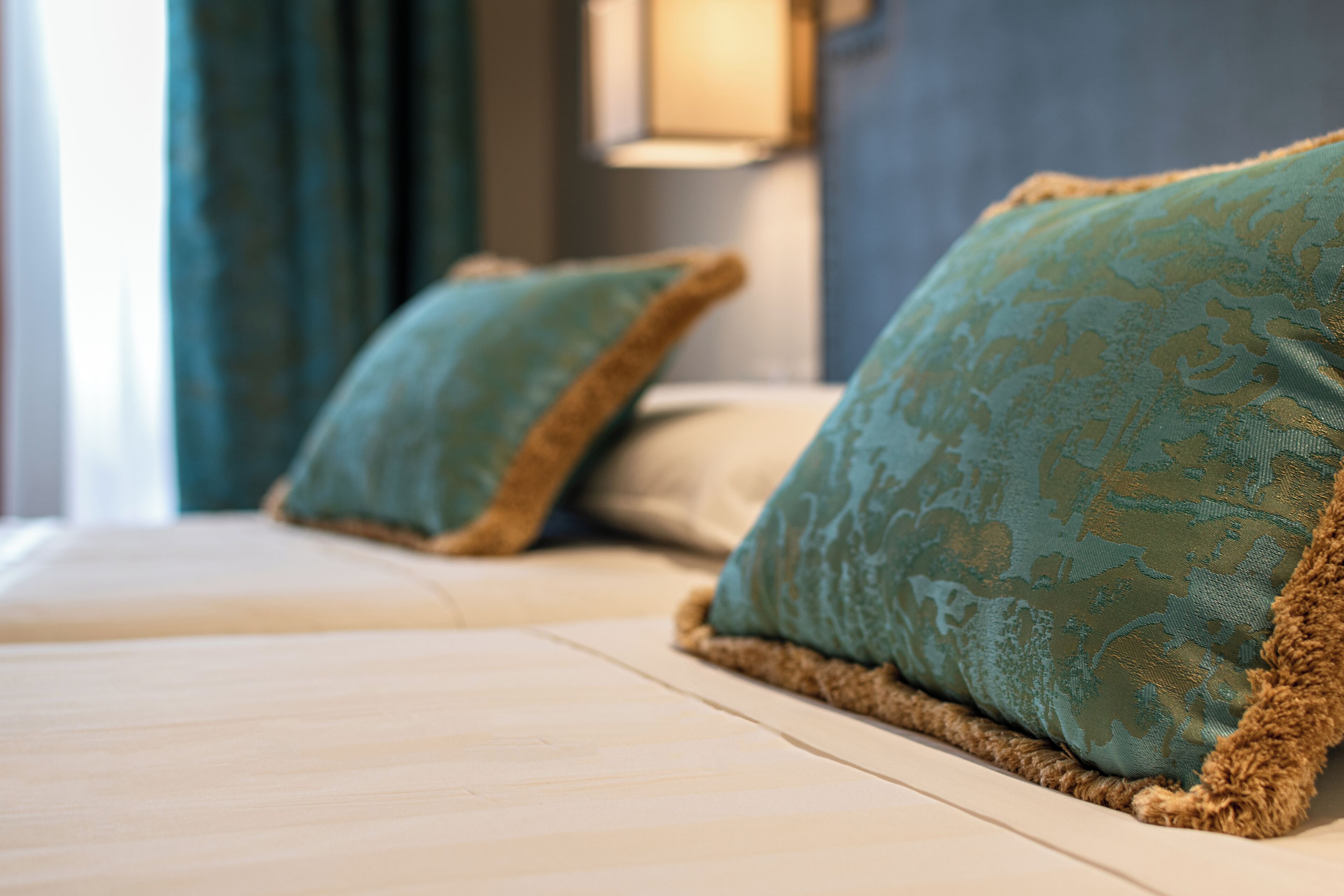 A bed with two pillows and a fluffy blanket.