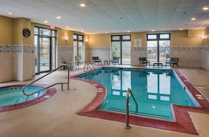 An indoor swimming pool with a red border, chairs, and a clock on the wall. - Holiday Inn Express Hotel and Suites Laurel by IHG (Laurel)