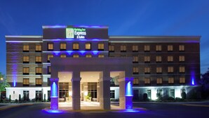A Holiday Inn Express & Suites building with a prominent entrance and a sign above the entrance.