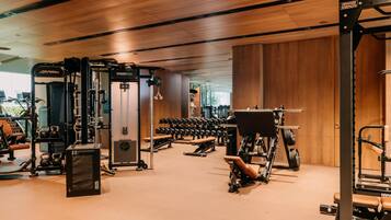 A gym with various exercise equipment, including weight machines and dumbbells.