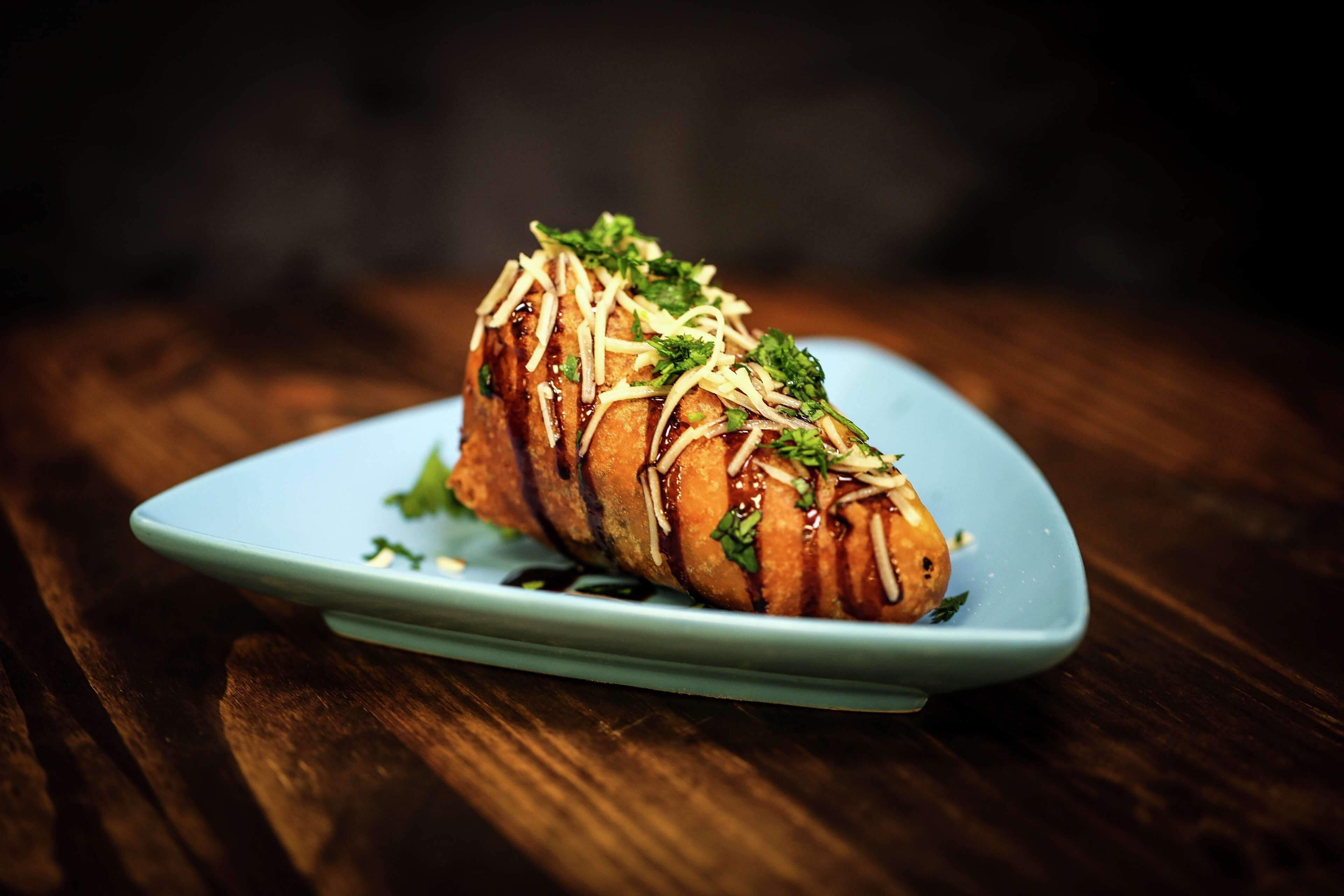 A dish on a blue plate with a wooden table background.