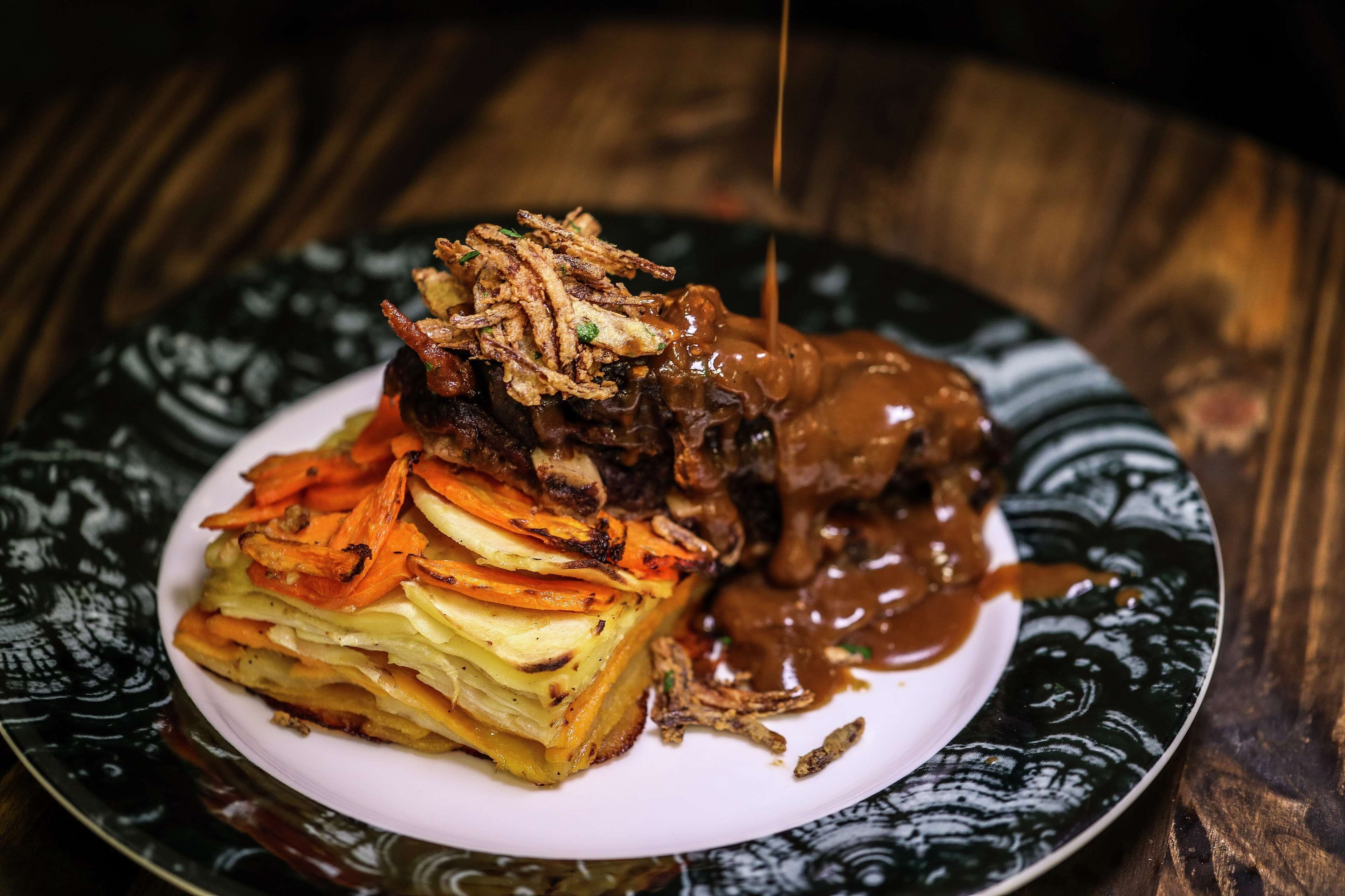 A plate of food with a variety of vegetables and a sauce.