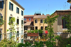 A row of traditional European buildings with balconies and potted plants. - Carlton Capri Hotel (Venice)