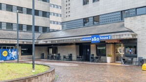 A modern building with an entrance labeled 'a&o house 2'. - a&o Hostel Milano Ca Granda (Milan)