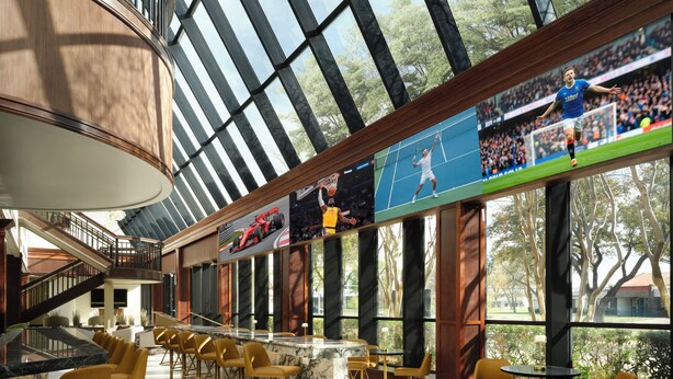 A modern interior with a bar area, seating, and large windows.