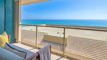 Un balcón con vista a la playa y al océano.