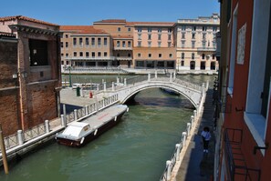 A canal with a bridge, boats, and buildings along the water. - Gardena Hotel (Venice)
