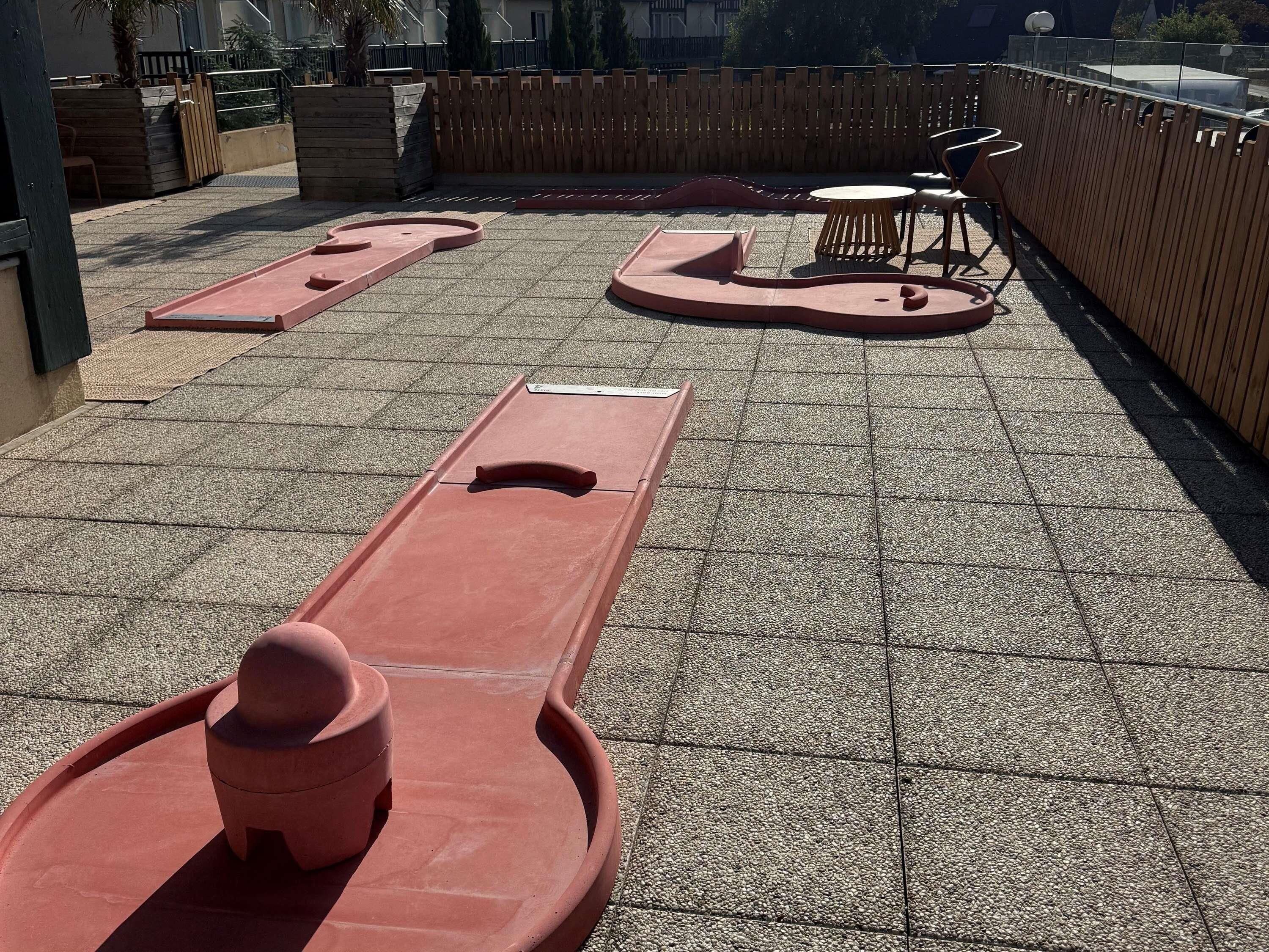 A rooftop terrace with a play area for children, including a slide and a climbing structure.