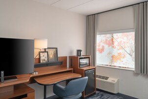 Premium bedding, desk, laptop workspace, blackout drapes