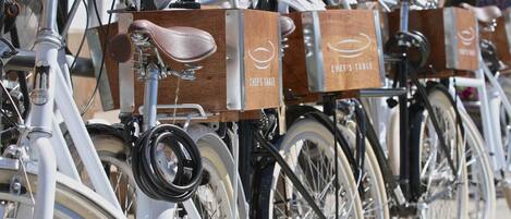 A row of bicycles with wooden boxes labeled "CHEF'S TABLE" attached to them.
