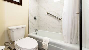 A bathroom with a toilet, a bathtub, and a shower.