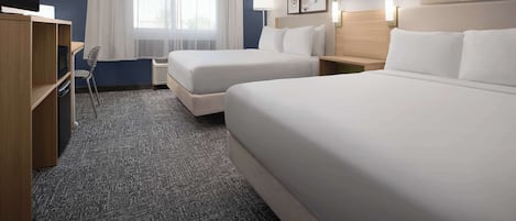 Ropa de cama de alta calidad y caja de seguridad en la habitación