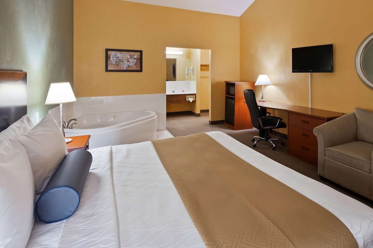 Desk, laptop workspace, iron/ironing board, bed sheets