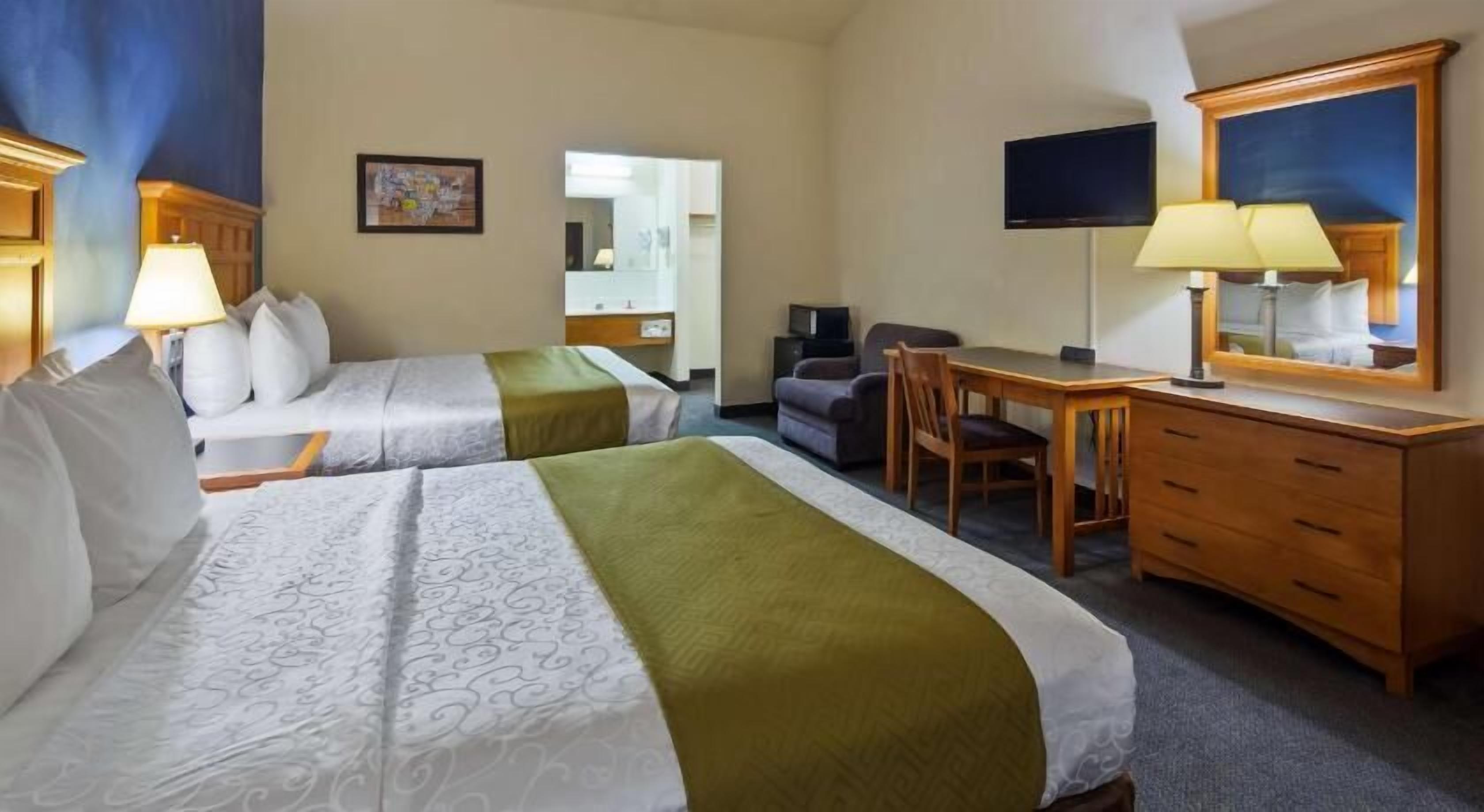 Desk, laptop workspace, iron/ironing board, bed sheets