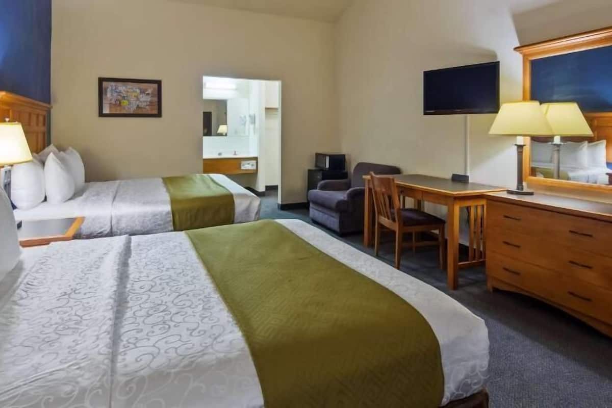 Desk, laptop workspace, iron/ironing board, bed sheets