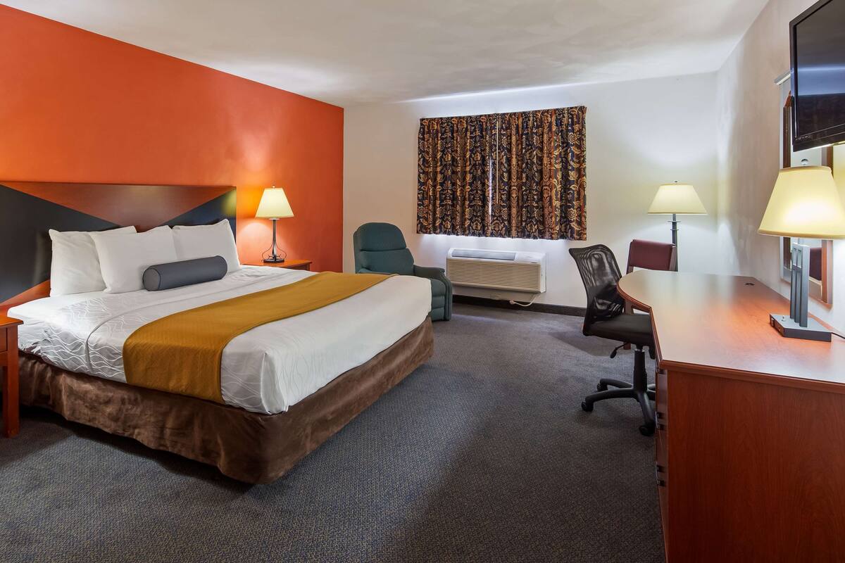 Desk, laptop workspace, iron/ironing board, bed sheets