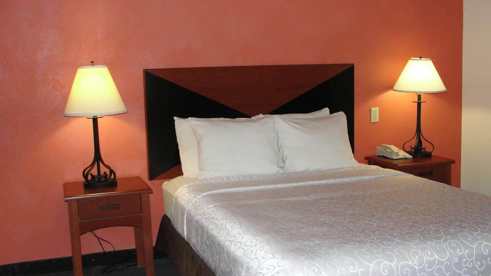 Desk, laptop workspace, iron/ironing board, bed sheets