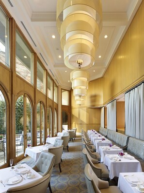 A restaurant with long tables, elegant chairs, and large windows. - The Rittenhouse Philadelphia (Philadelphia)