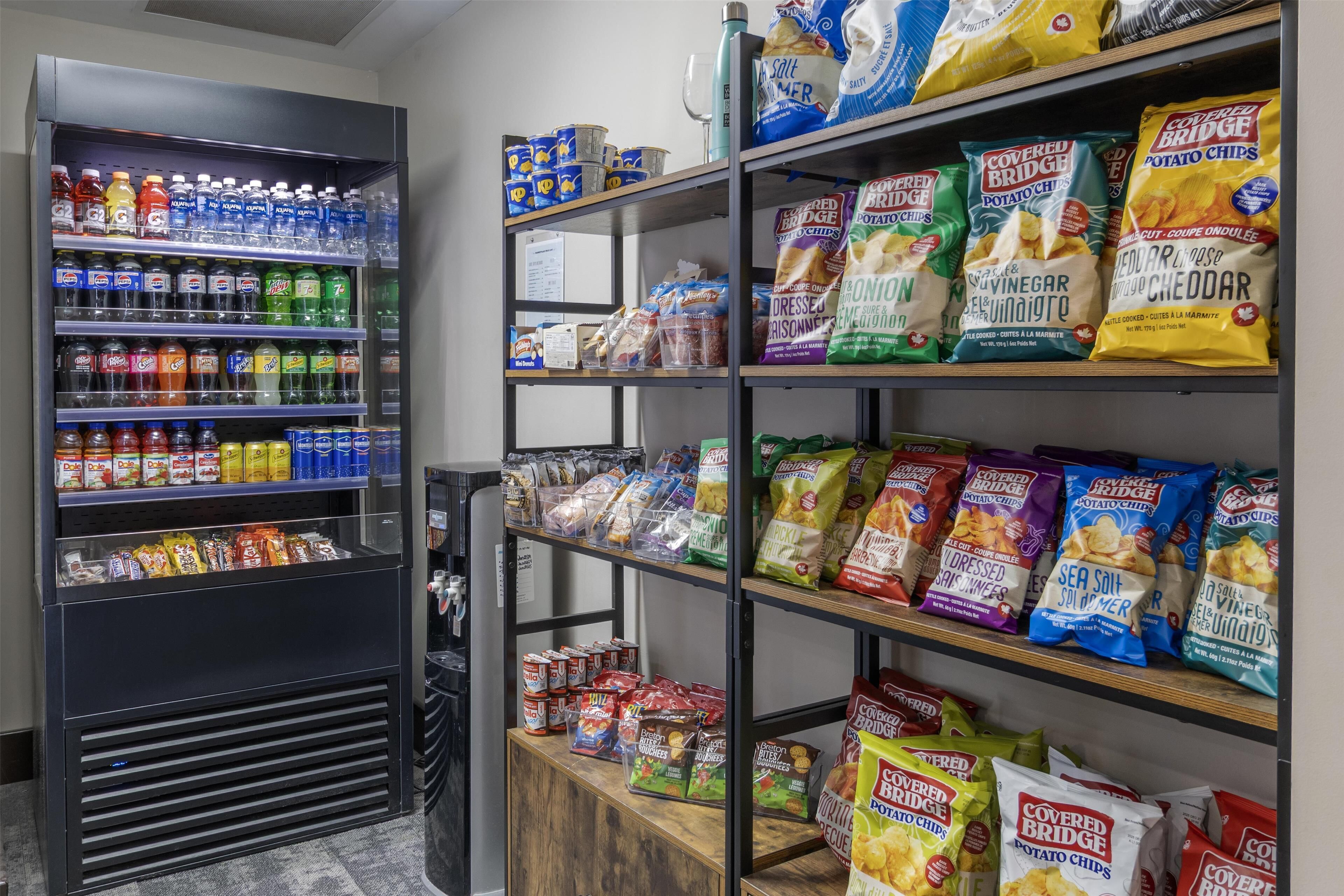 A snack and beverage vending machine stocked with various drinks and snacks.