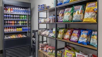 A snack and beverage vending machine stocked with various drinks and snacks.