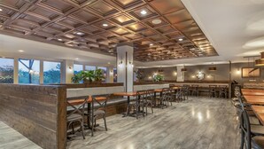 A modern restaurant with a wooden ceiling, large windows, and a bar area. - Best Western Plus Chocolate Lake Hotel (Halifax)