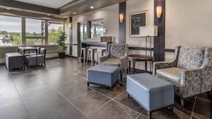 A modern lounge area with seating, a bar, and large windows offering views. - Best Western Plus Chocolate Lake Hotel (Halifax)