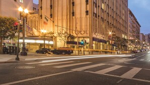 A large, multi-story hotel with a prominent entrance and a series of balconies. - The Donatello (San Francisco)