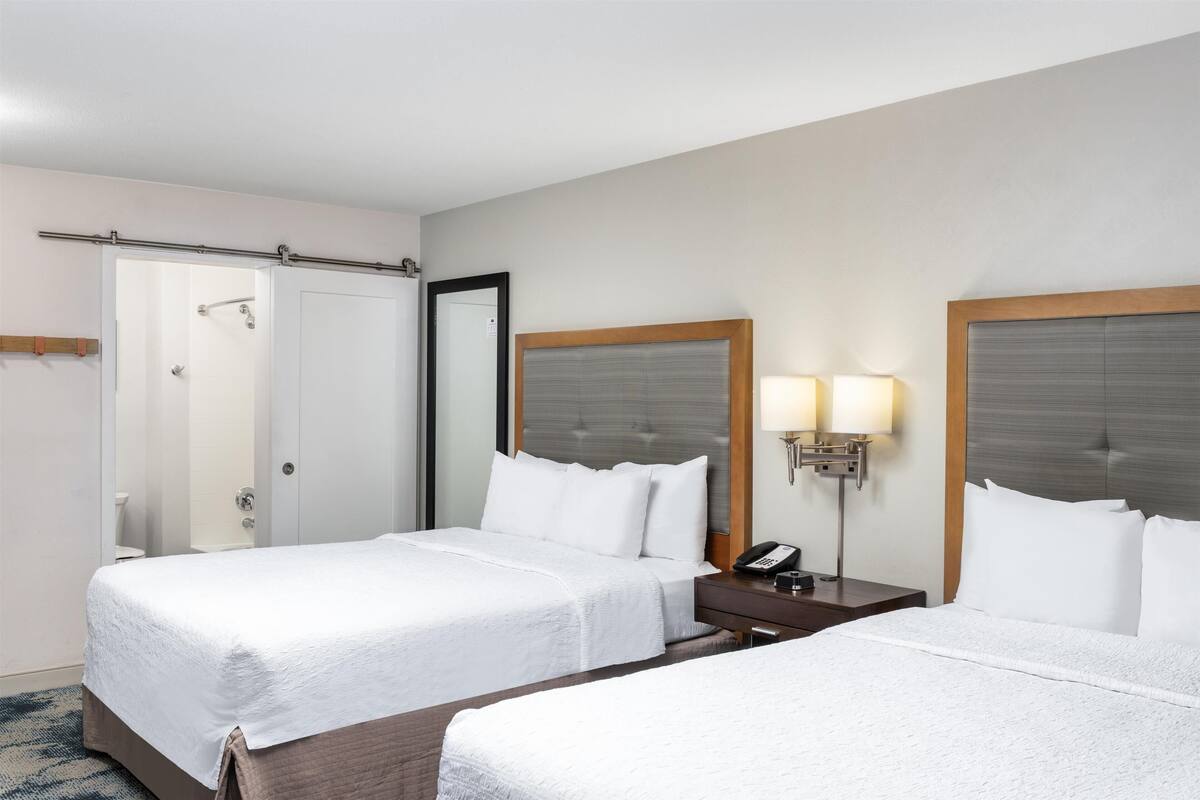 Standard room with two double beds | In-room safe, desk, iron/ironing board, cribs (free)