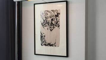 A framed artwork on a textured wall.
