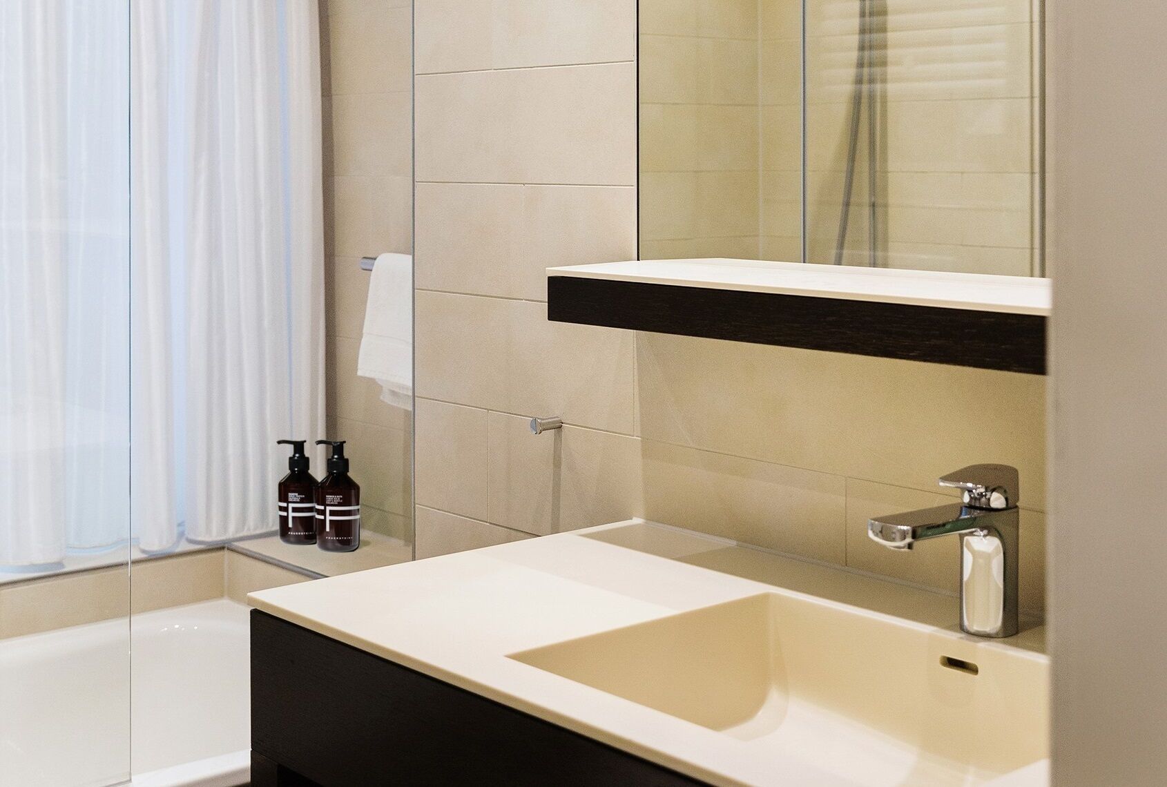 designer toiletries, hair dryer, slippers, towels