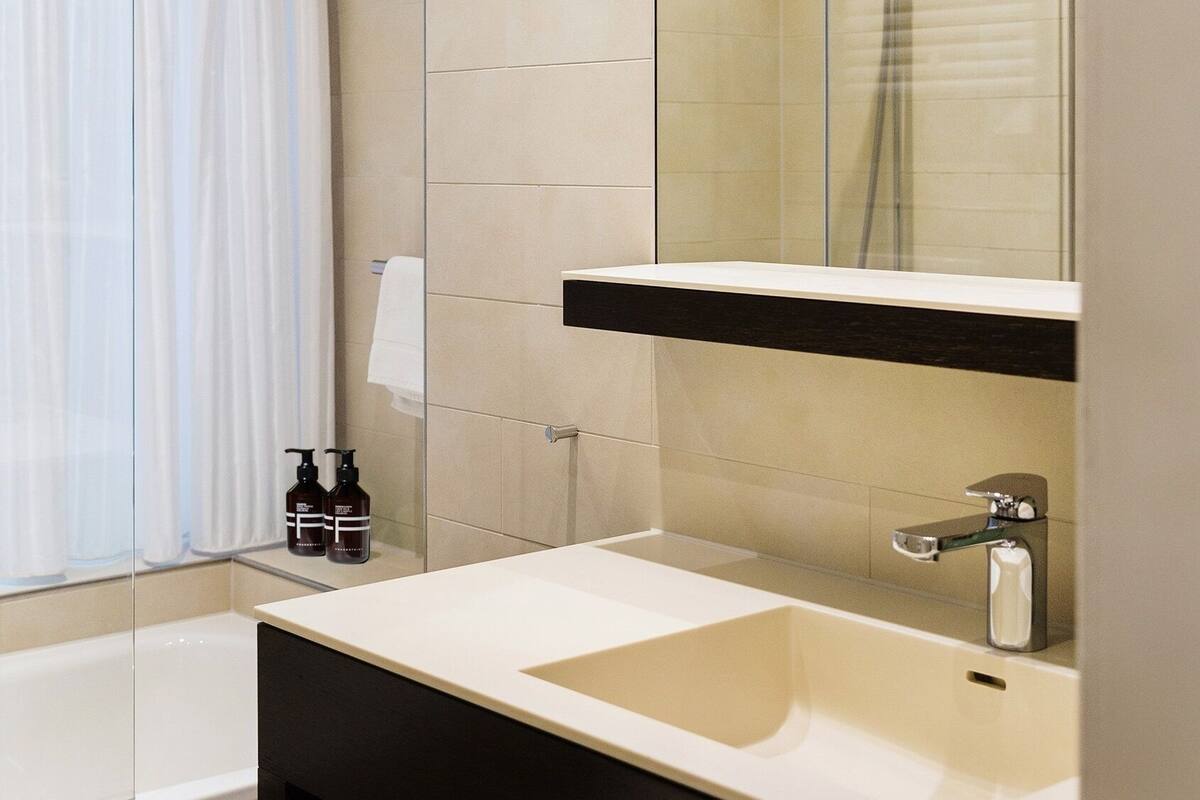 designer toiletries, hair dryer, slippers, towels