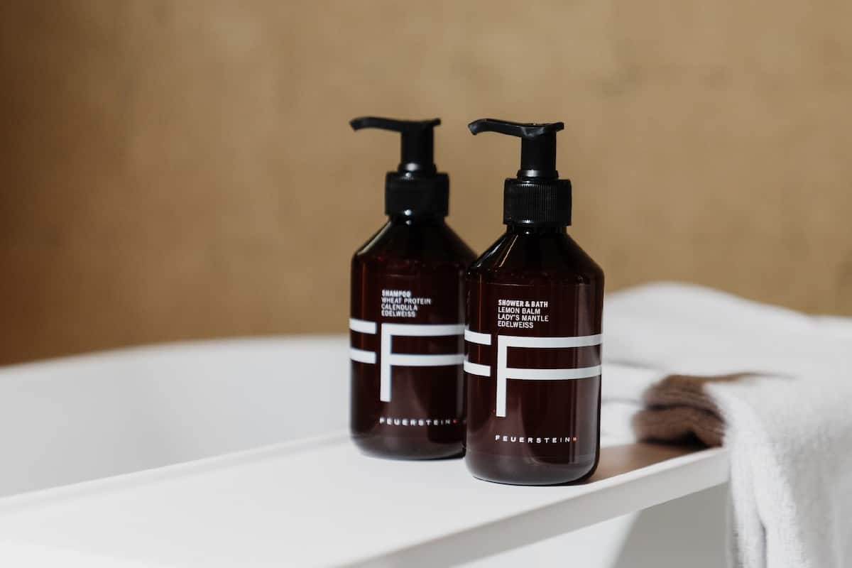 designer toiletries, hair dryer, slippers, towels