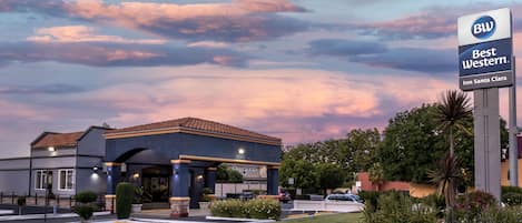 A Best Western Inn Santa Clara with a clear sky and parking lot.