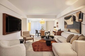 Relax in comfort with a large flat-screen TV, sofa set, and dining area.