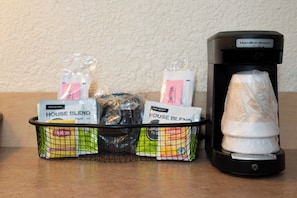 A coffee maker and a basket of tea bags on a countertop. - Red Roof Inn Tampa Fairgrounds – Casino (Tampa)