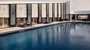 A modern pool area with lounge chairs and a clear view of the pool.