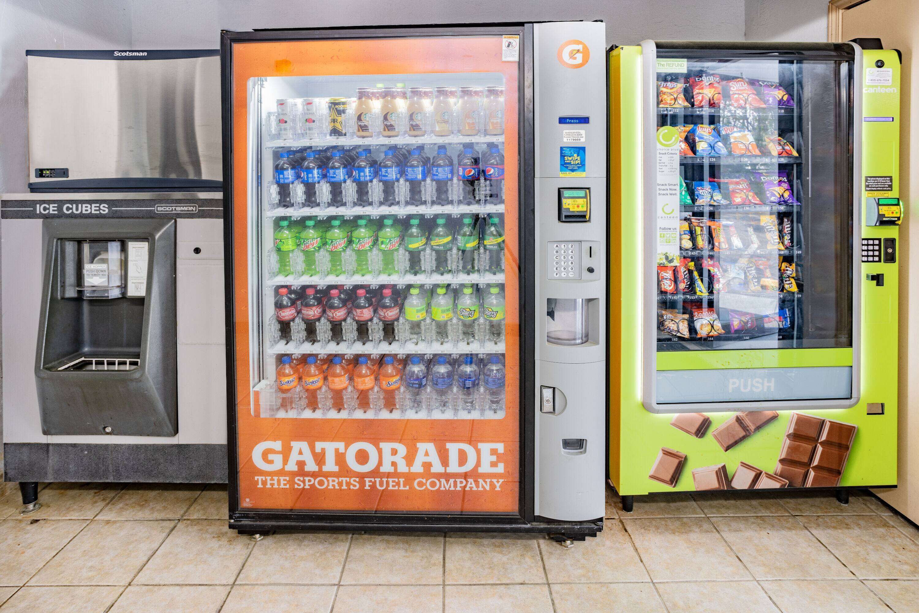 A vending machine with a Gatorade advertisement, a water dispenser, and a snack vending machine.