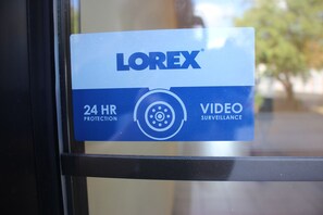 A security sign with the text "LOREX 24 HR PROTECTION VIDEO SURVEILLANCE". - Extend-a-Suites - Extended Stay, I-40 Amarillo West (Amarillo)