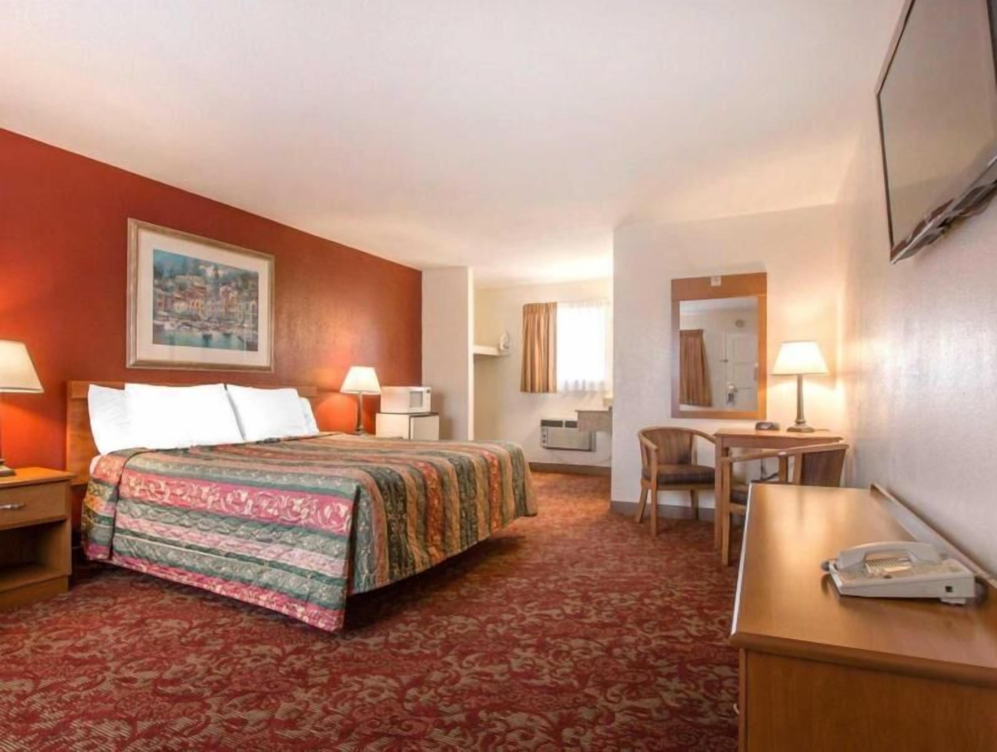 Desk, laptop workspace, blackout drapes, iron/ironing board