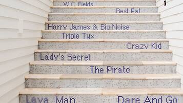 A staircase with steps labeled with names from various stories and books.