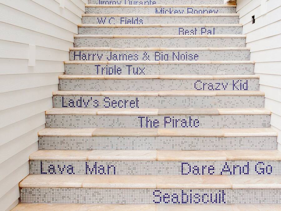 A staircase with steps labeled with names from various stories and books.
