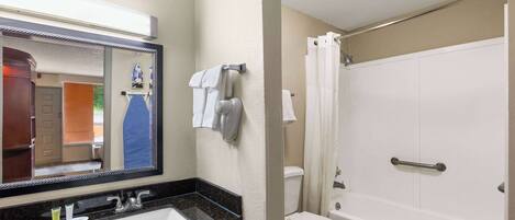 A bathroom with a sink, mirror, and toilet.