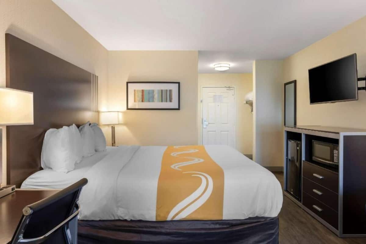 Premium bedding, desk, laptop workspace, blackout drapes