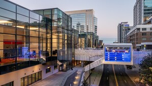 A modern building with large glass windows and a well-lit interior. - Sheraton Charlotte Hotel (Charlotte)