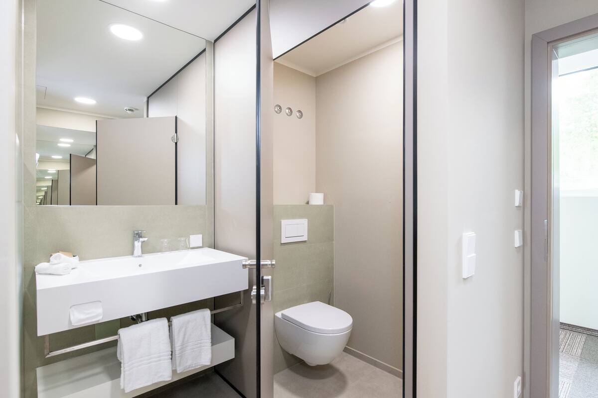 comfort double room, balcony, lake view | bathroom | shower, rainfall showerhead, hair dryer, bathrobes