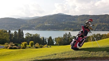 Golfers can tee off from the well-manicured course, overlooking a serene lake and rolling hills.