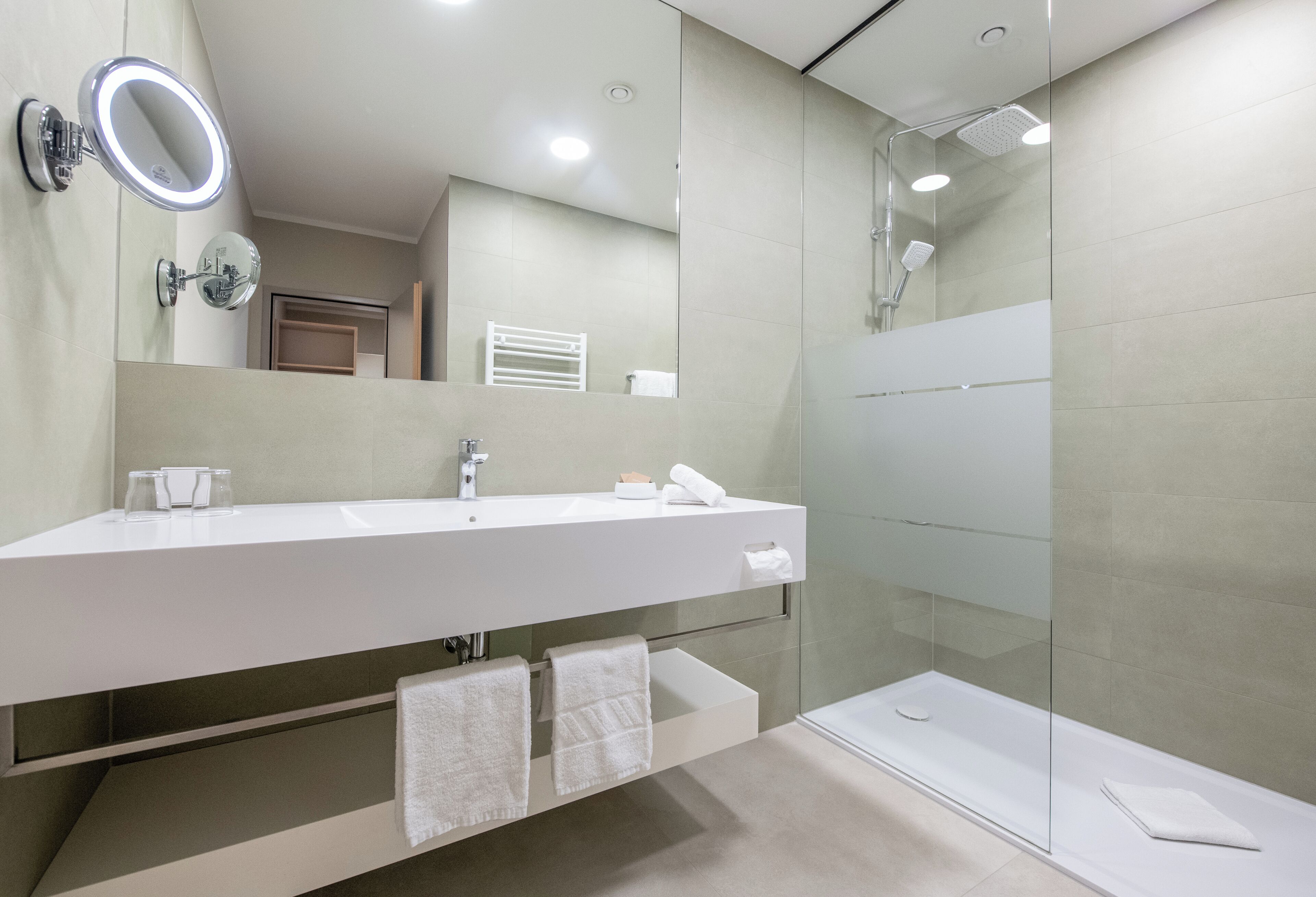 junior suite | bathroom | shower, rainfall showerhead, hair dryer, bathrobes