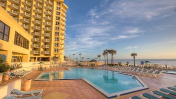 Una piscina cubierta, una piscina al aire libre, sombrillas, tumbonas
