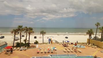 Alberca techada, alberca al aire libre y sombrillas en la alberca