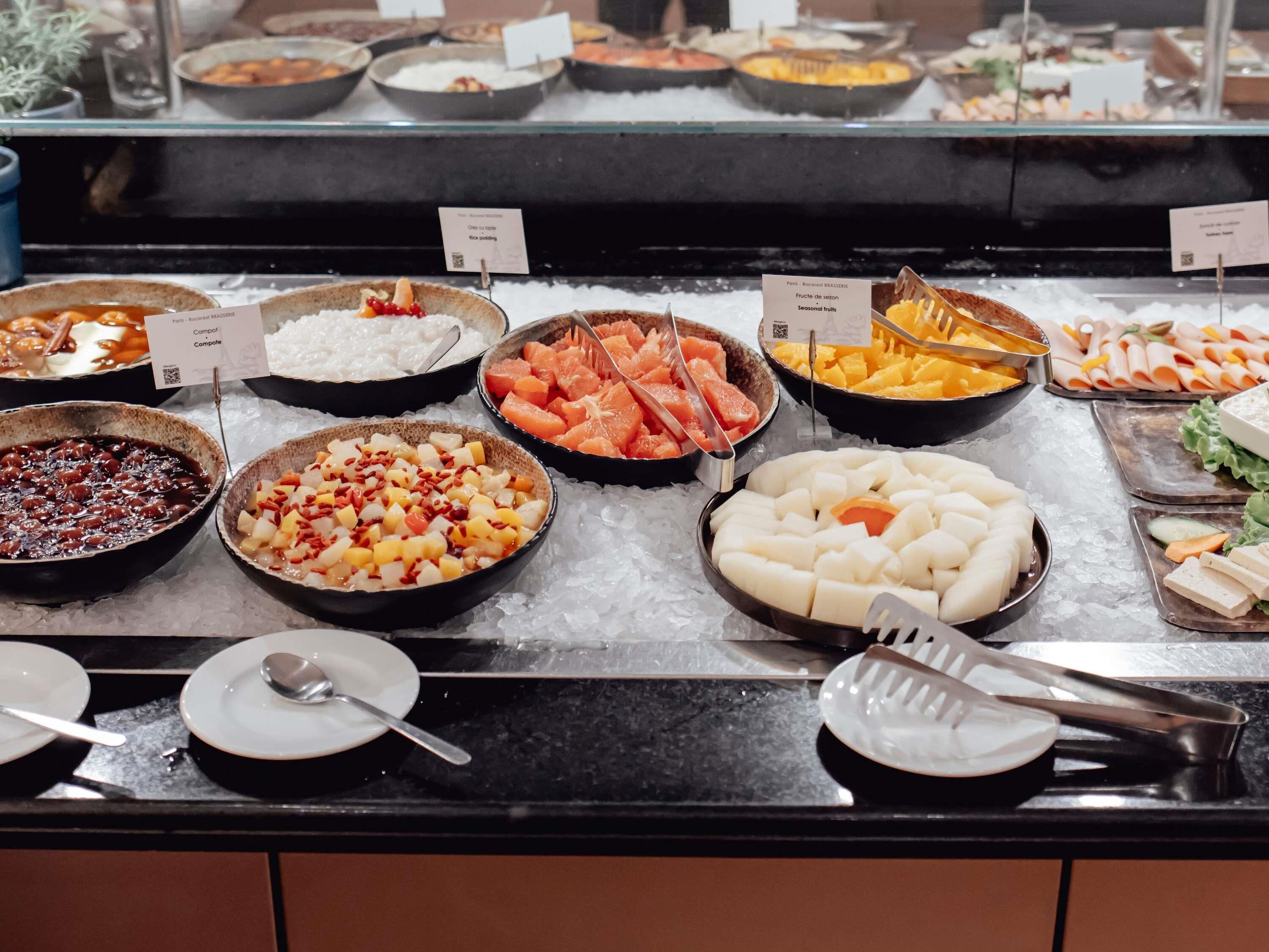 A buffet with various food items displayed on ice.